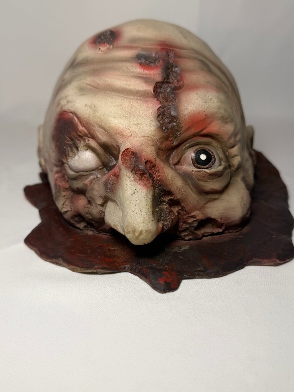 Half of a Severed Head Blood Pool Halloween Horror Prop Latex Open Eye Zombie